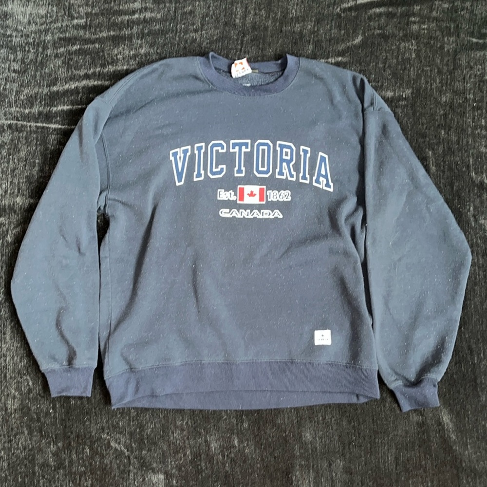 XL fits like an in between L/XL Victoria Canada Navy crewneck